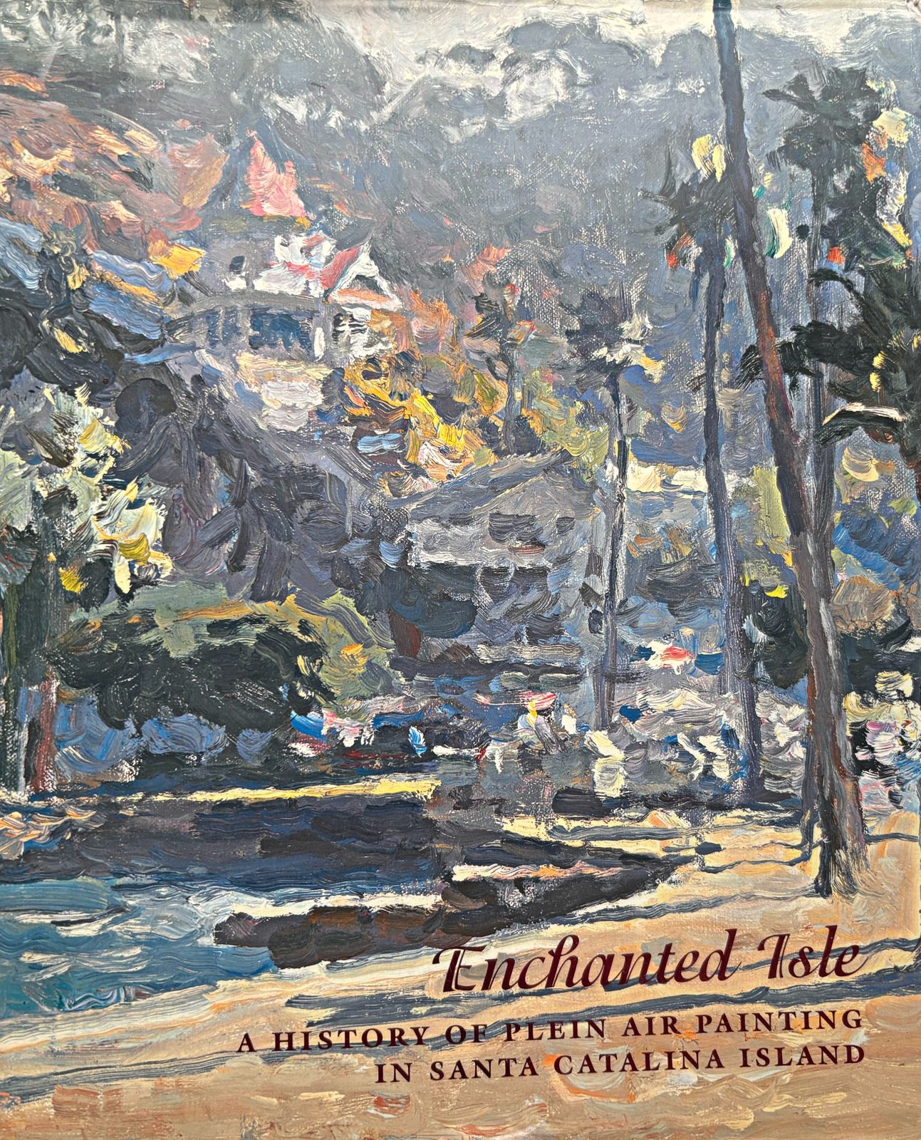 Cover of the book Enchanted Isle: A History of Plein Air Painting in Santa Catalina Island, showing an impressionist painting of Avalon hillside homes and palms